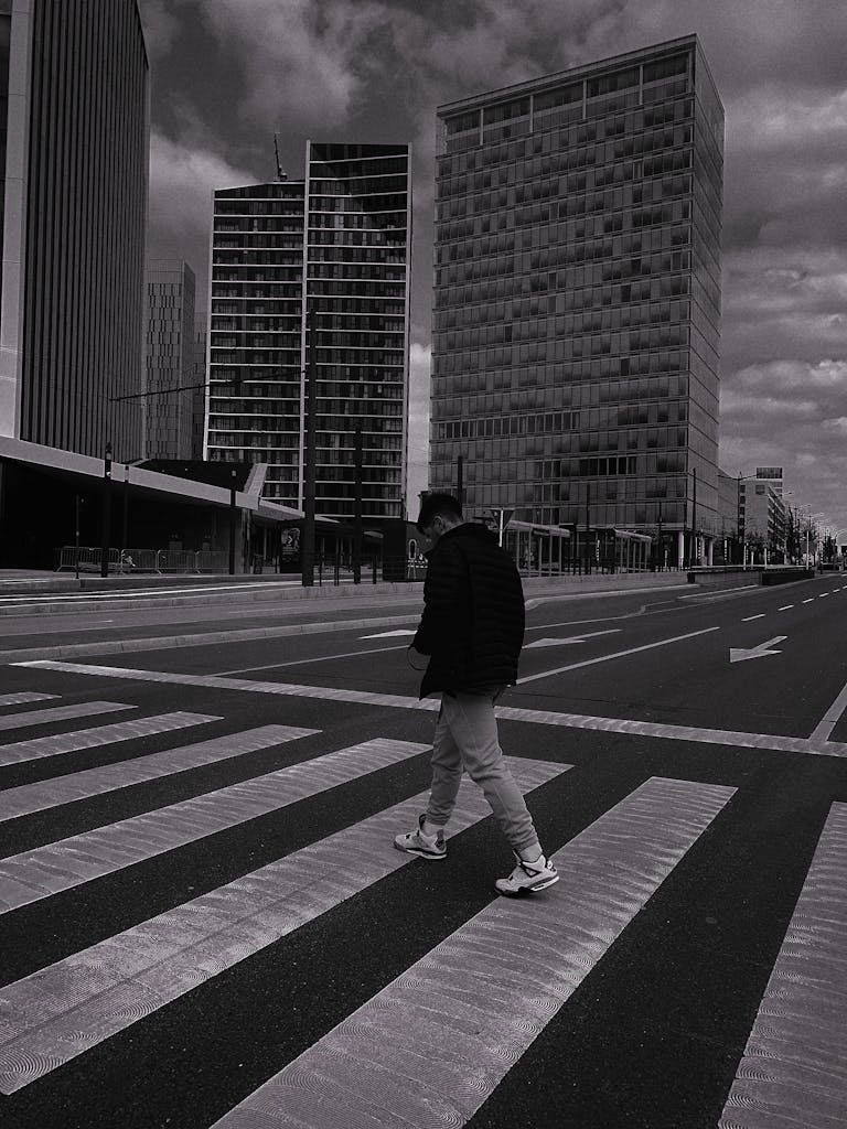 A black and white image of a man crossing a city street, reflecting how life can feel empty and colorless for someone experiencing anhedonia.