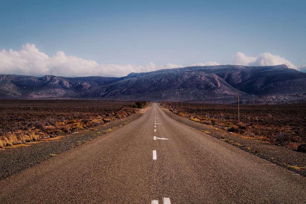 Captivating view of an endless road leading through the rugged Karoo desert in Western Cape, South Africa.