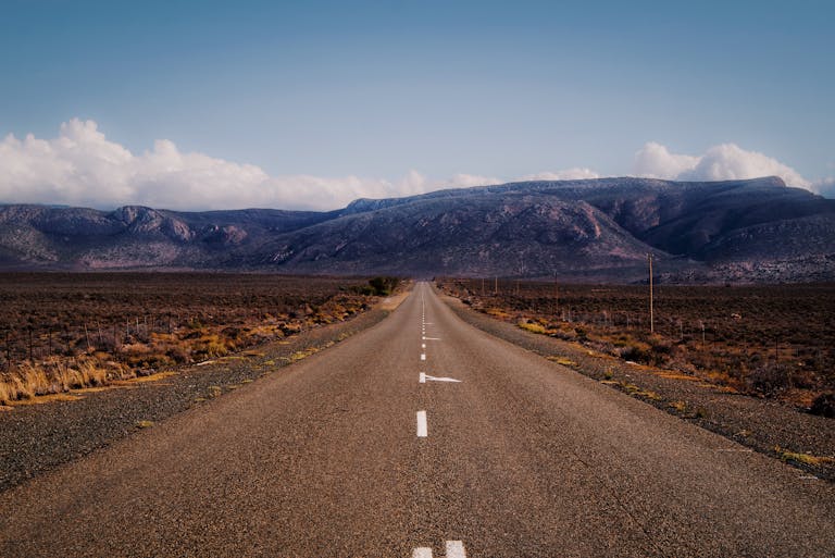 Captivating view of an endless road leading through the rugged Karoo desert in Western Cape, South Africa.